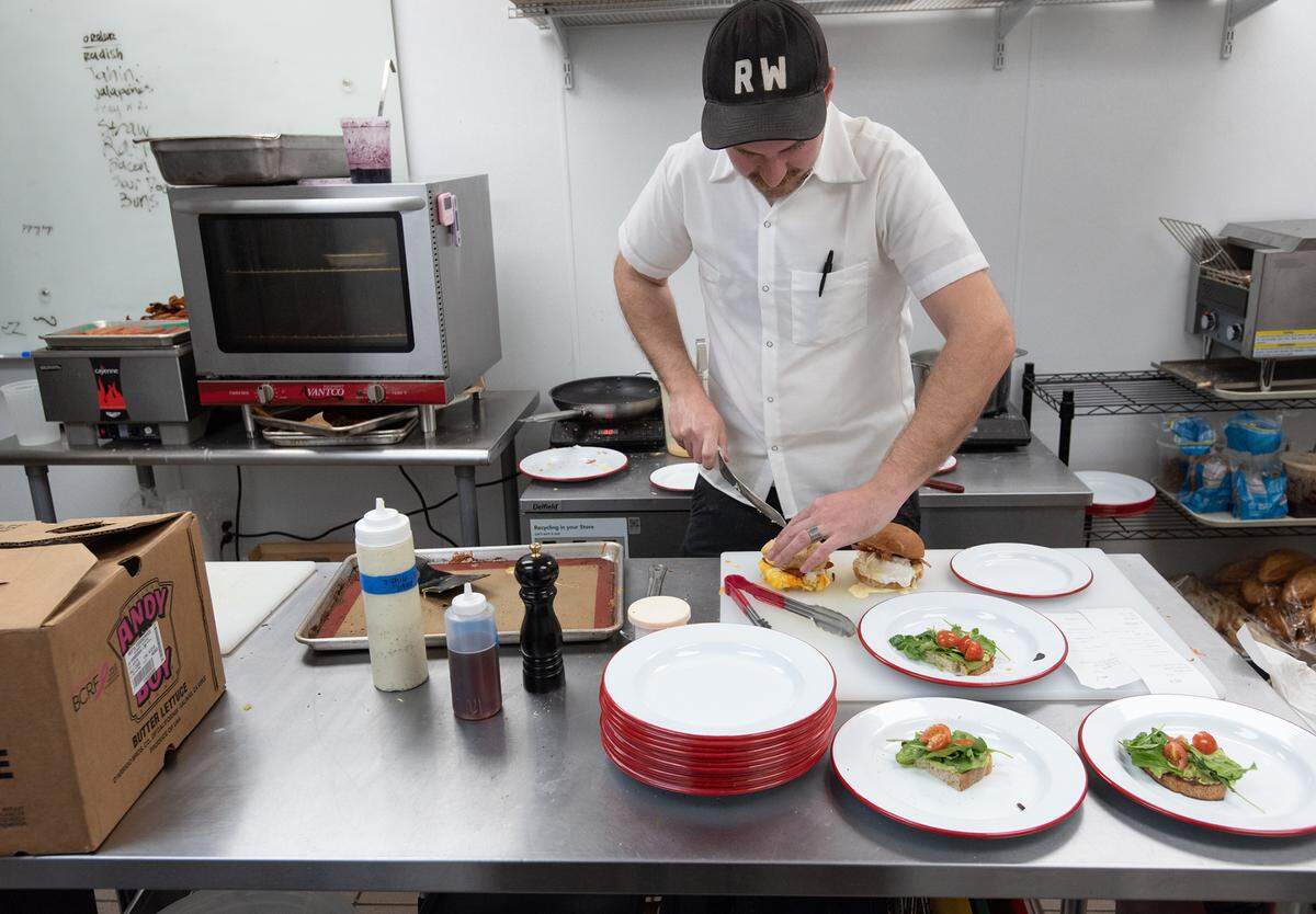 Lucille co-owner Wyatt Smith prepares breakfast meals during a morning rush in Modesto, Calif., Friday, Feb. 3, 2023.