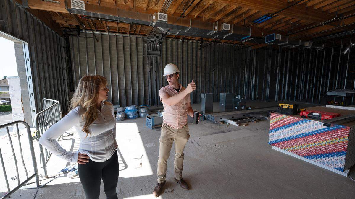 Ride 209 owner Michele Petlansky, left, talks with construction manager Luke Chipponeri at the gym’s new building under construction in Ripon, Calif., Thursday, May 2, 2024. The two are standing in one of the larger workout spaces on the second floor.