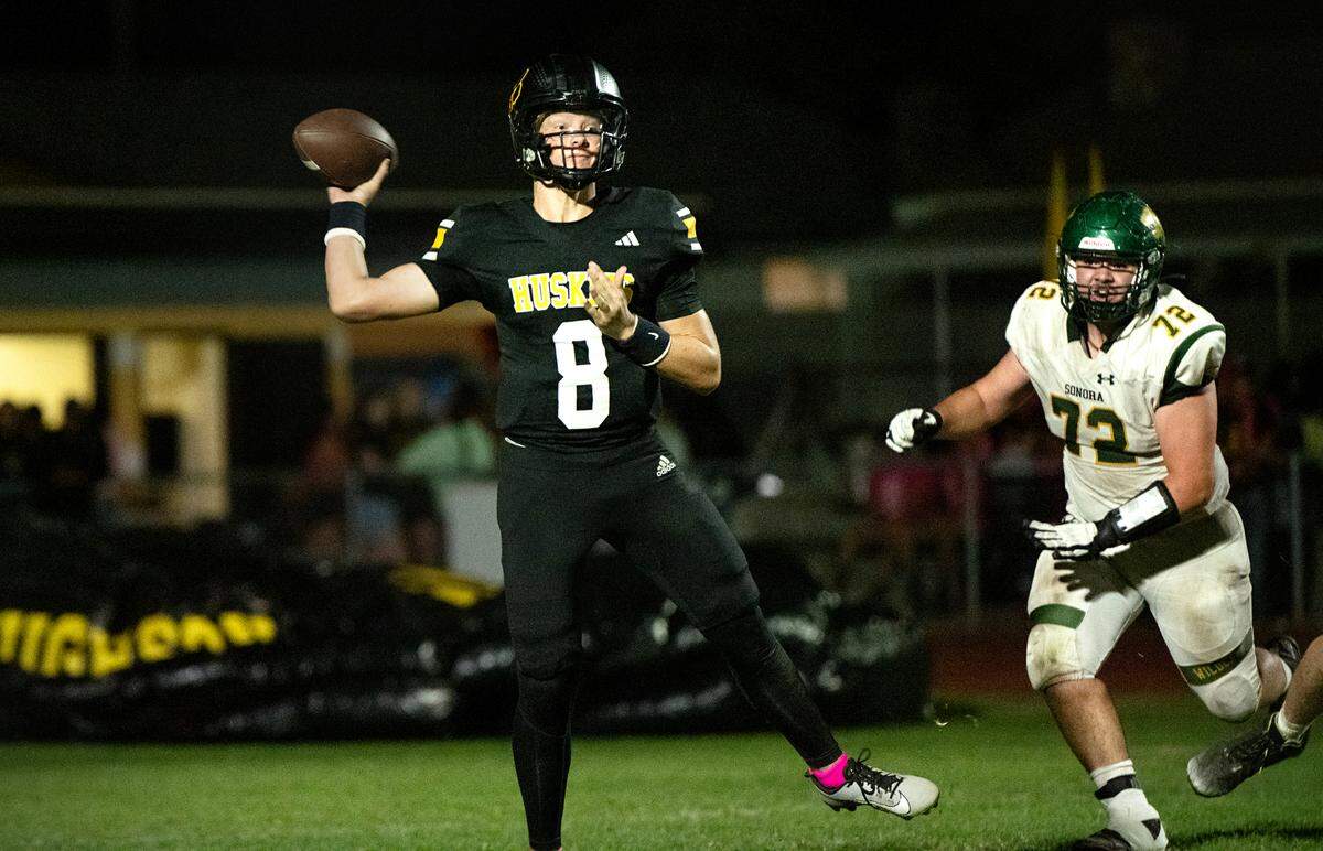 Hughson’s Robert McDaniel rolls out for a pass during the Trans Valley League game with Sonora in Hughson, Friday, Oct. 11, 2024.