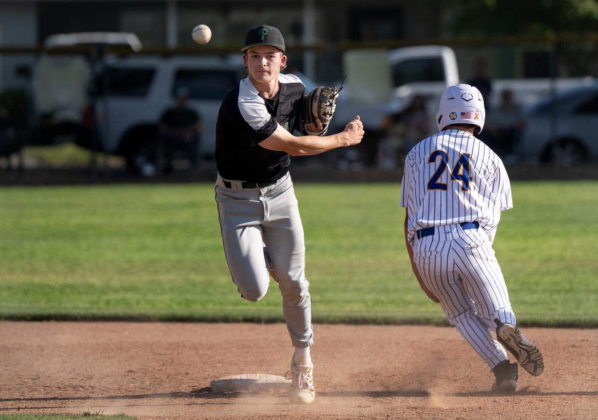 Pitman’s Nolan Walker forces out Turlock runner Chris Allerton (24) on a double play during the California Athletic League game at Turlock High School in Turlock, Monday, April 14, 2025.