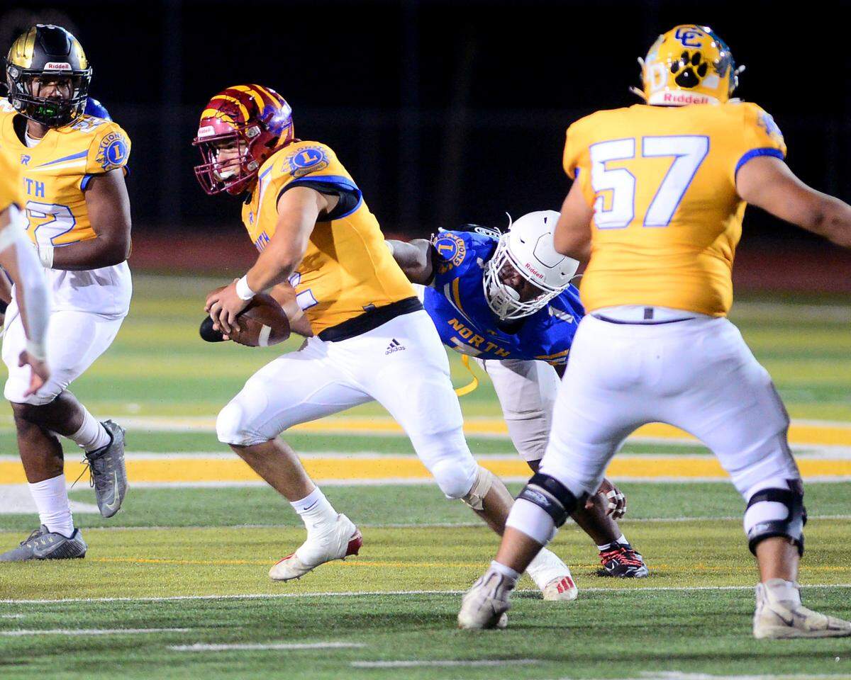 Los Banos quarterback David Herrera (2) scrambles out of the pocket during the 2024 Lions All-Star High School Football game at Tracy High School in Tracy, Calif. on June 22, 2024.