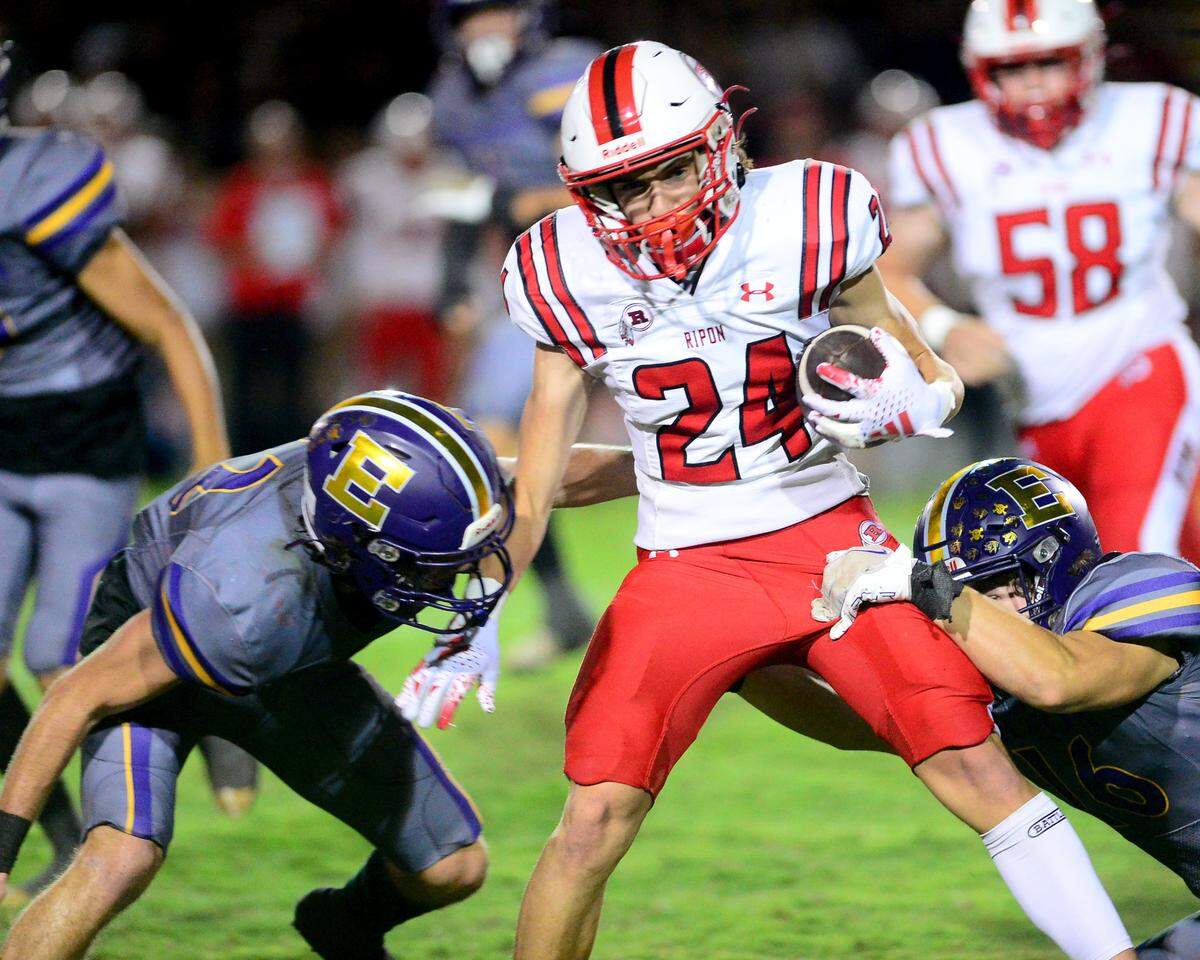 Ripon receiver Dru Orlando (24) gets hit by Escalon defenders during a game between Escalon High School and Ripon High School in Escalon, California on October 20, 2023. 