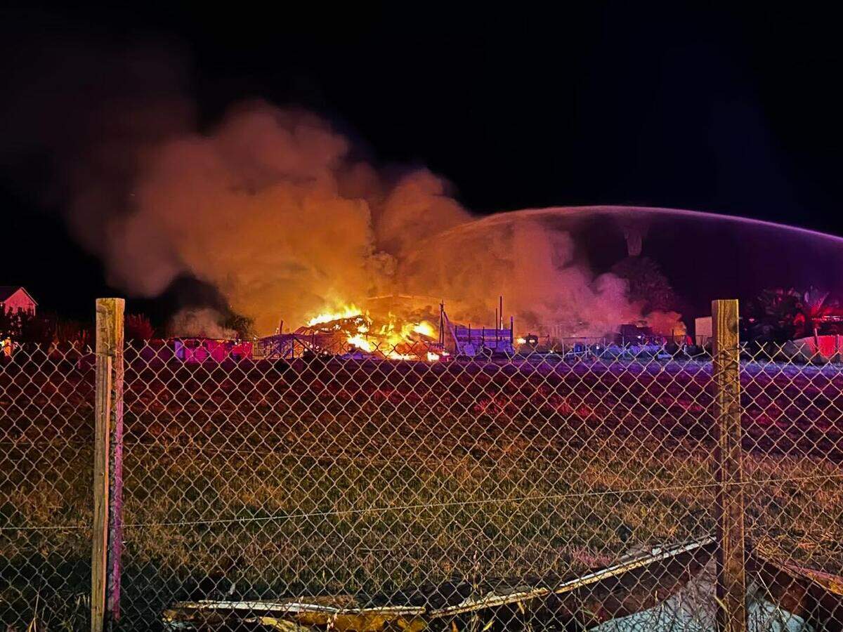 Multiple fire agencies from throughout the county sent resources to battle a massive barn fire Friday night, April 18, 2025, in the 200 block of Poppy Avenue in Patterson.