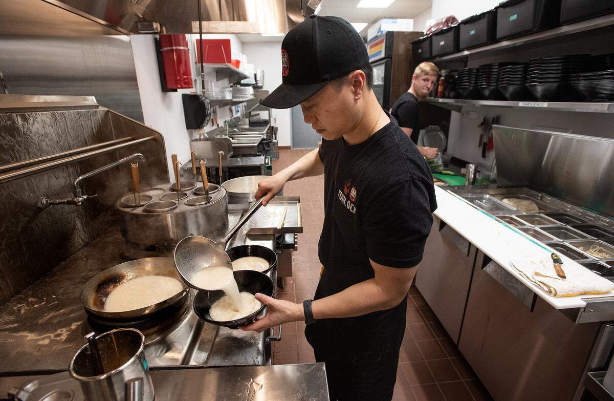 Co-owner Trevor Diep ladles broth as he prepares a bowl of ramen at Daraman ramen house in Turlock, Calif., on Thursday, June 9, 2022.