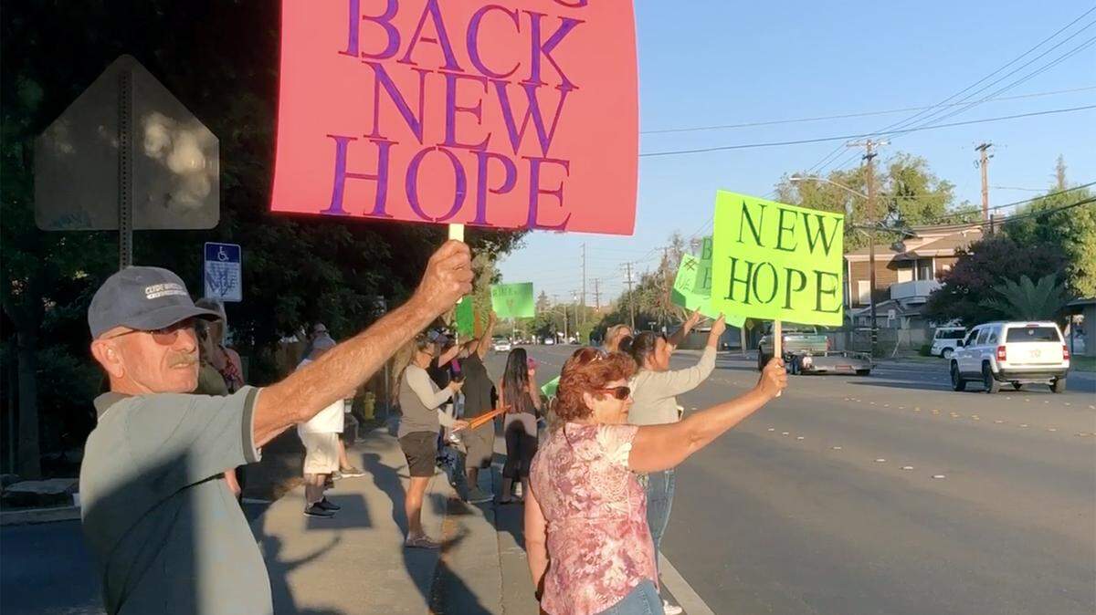 People are pictured Friday September 20, 2019 at a rally outside New Hope Recovery on E Orangeburg avenue in Modesto, Calif.