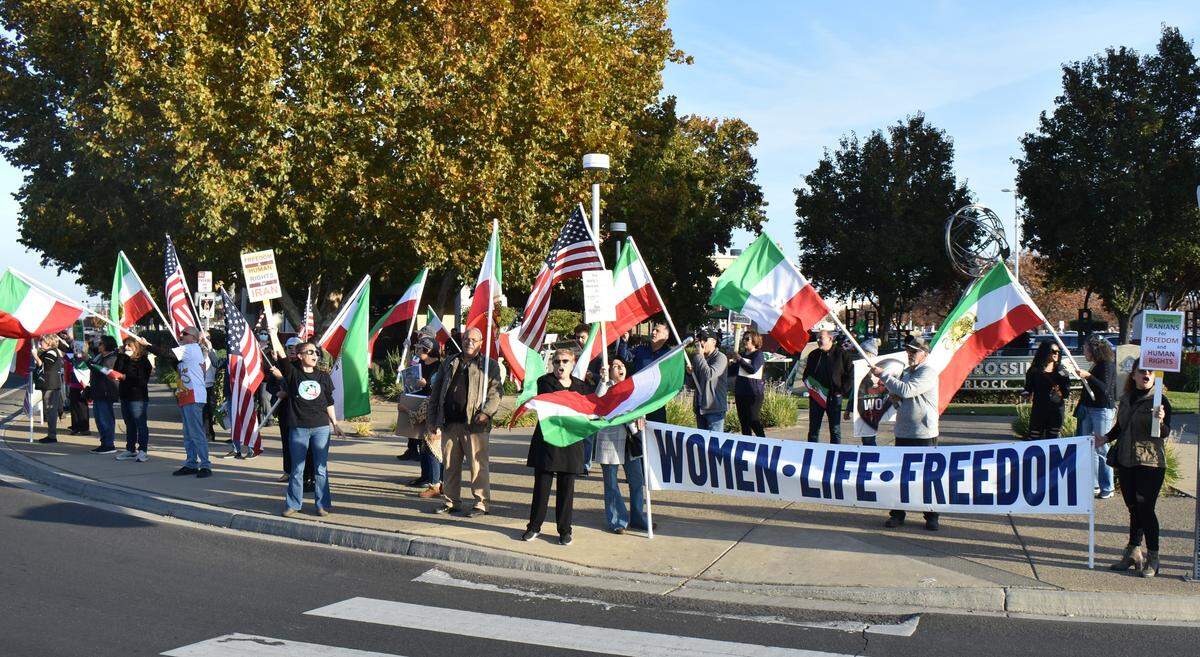 Dozens of people gathered at a Turlock intersection the afternoon of Sunday, Nov. 20, 2022, to protest against the Islamic Republic of Iran. They called for democracy, human rights and an end to the Islamic regime.
