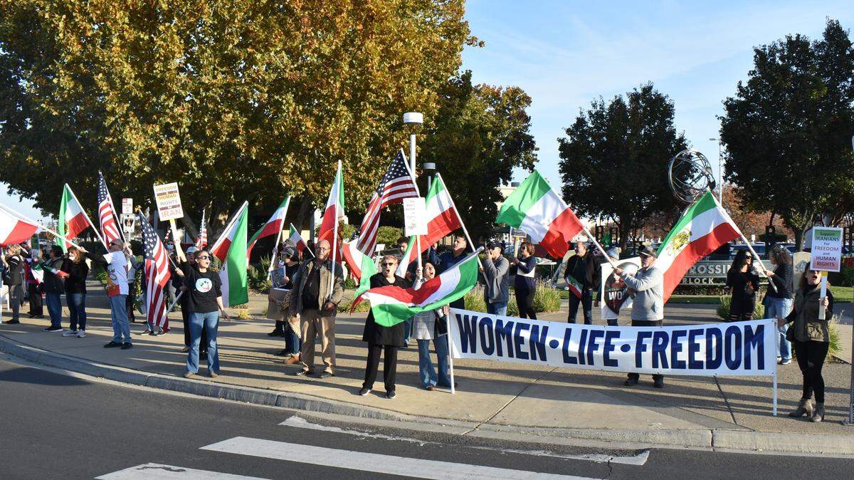 Dozens of people gathered at a Turlock intersection the afternoon of Sunday, Nov. 20, 2022, to protest against the Islamic Republic of Iran. They called for democracy, human rights and an end to the Islamic regime.