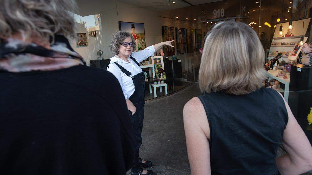 Merchandising and business consultant Michele Reeves talks about the window treatment she and her team created at Chartreuse Muse art gallery on 10th Street in Modesto, Calif., on Thursday, Oct. 28, 2021.