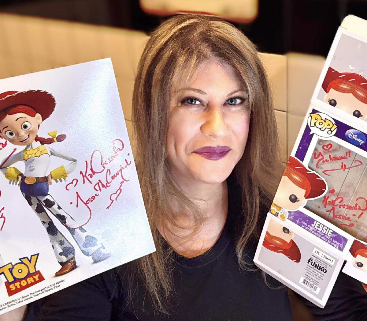 Kat Cressida with signed memorabilia of her voice characters.
