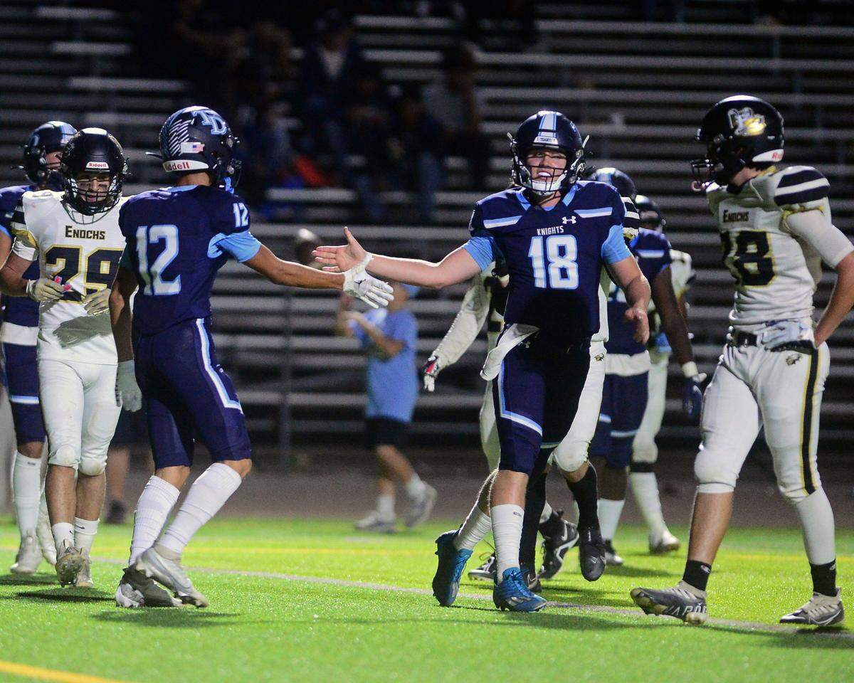 Downey quarterback Coner Stoddard (18) celebrates a touchdown with Gabe Hernandez (12)during a game between Downey High School and Enochs High School at Downey High School in Modesto CA on October 13, 2022.