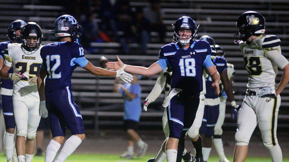 Downey quarterback Coner Stoddard (18) celebrates a touchdown with Gabe Hernandez (12)during a game between Downey High School and Enochs High School at Downey High School in Modesto CA on October 13, 2022.