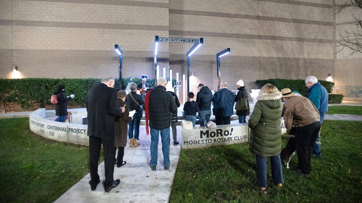 A small group sings with Congregation Beth Shalom Rabbi Shalom Bochner during the lighting of the menorah on the third day of Hanukkah outside the Gallo Center for the Arts in Modesto on Dec. 20, 2022.