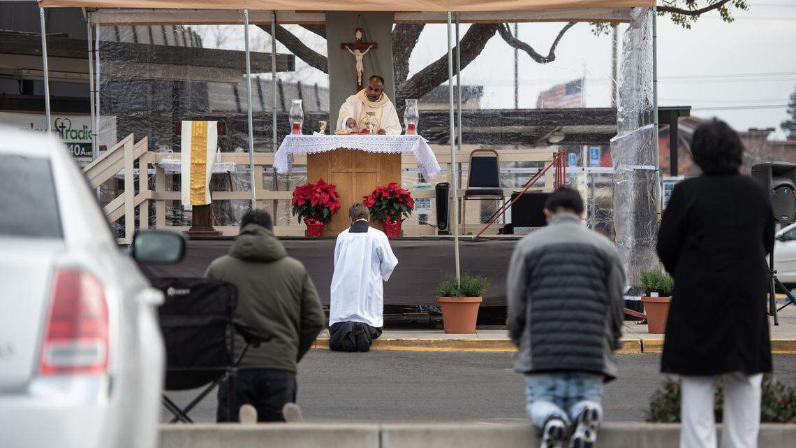 Parishioners attend an outdoor Christmas day mass at St. Joseph’s Catholic Church in Modesto, Calif., Friday, Dec. 25, 2020.