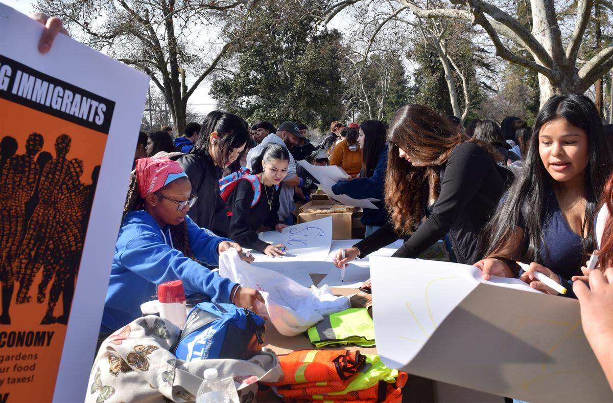Students create signs for their protest at Crane Park in Turlock, Friday, Jan. 30, 2026.