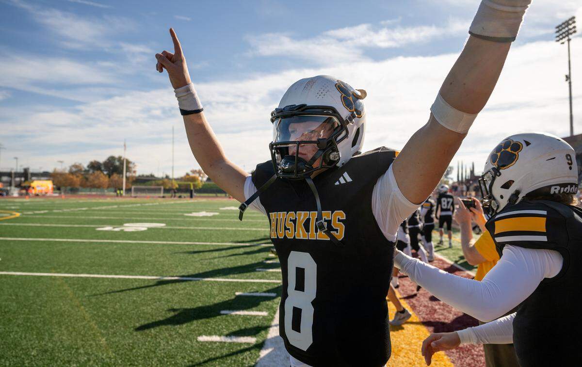Hughson quarterback Robert McDaniel signals victory after he and teammates won the Sac-Joaquin Section Division 5 championship game over Sutter at Sacramento City College in Sacramento, Saturday, Nov. 30, 2024.