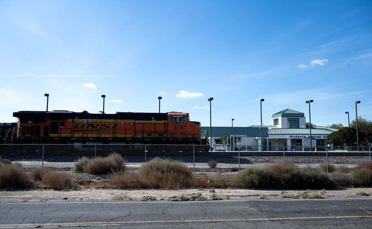 A freight train passes the Amtrak Station in Modesto, Thursday, Oct. 31, 2024.