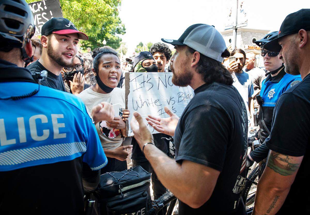 Demonstrators and counterdemonstrators verbally confront each other during a demonstration in support of George Floyd in Oakdale, Calif., on Wednesday, June 3, 2020. Several hundred people gathered in downtown Oakdale for a demonstration in response to the death of a black man in police custody in Minnesota last week.