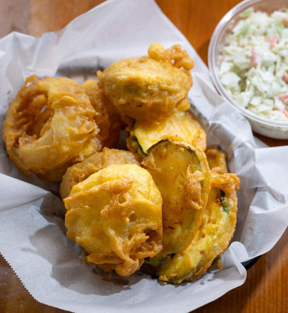 Veggie combo (zucchini, mushrooms, onion rings) with a side of coleslaw at Ann’s Fish & Chips in Hughson, Thursday, April 17, 2025.