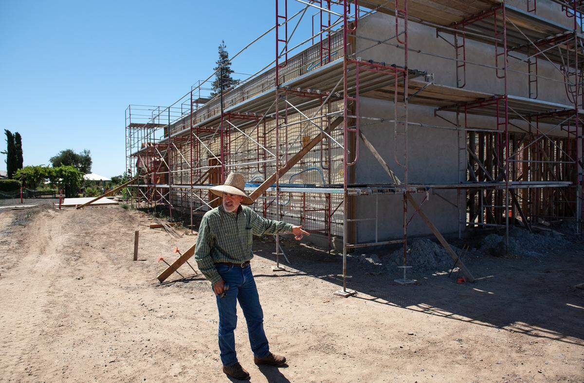 Michael Franzia points out the winery structure being built that will also have an outdoor patio and tasting room at Zinc House Farm in Escalon, Calif., on Tuesday, June, 21, 2022.