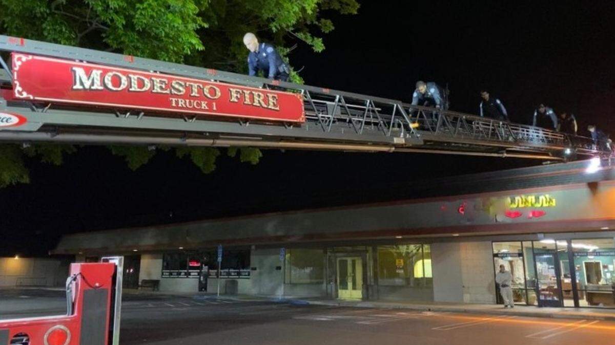 After trying to break into at least one of the Wells Fargo ATMs in the Century Center shopping center in Modesto, two men tried to escape police by entering the building’s attic and lowering themselves into the neighboring business Terry’s Touch of Gold. Police used a Modesto Fire Department ladder truck to enter the attic. Note: The Fire Department obscured the Touch of Gold name in this photo.