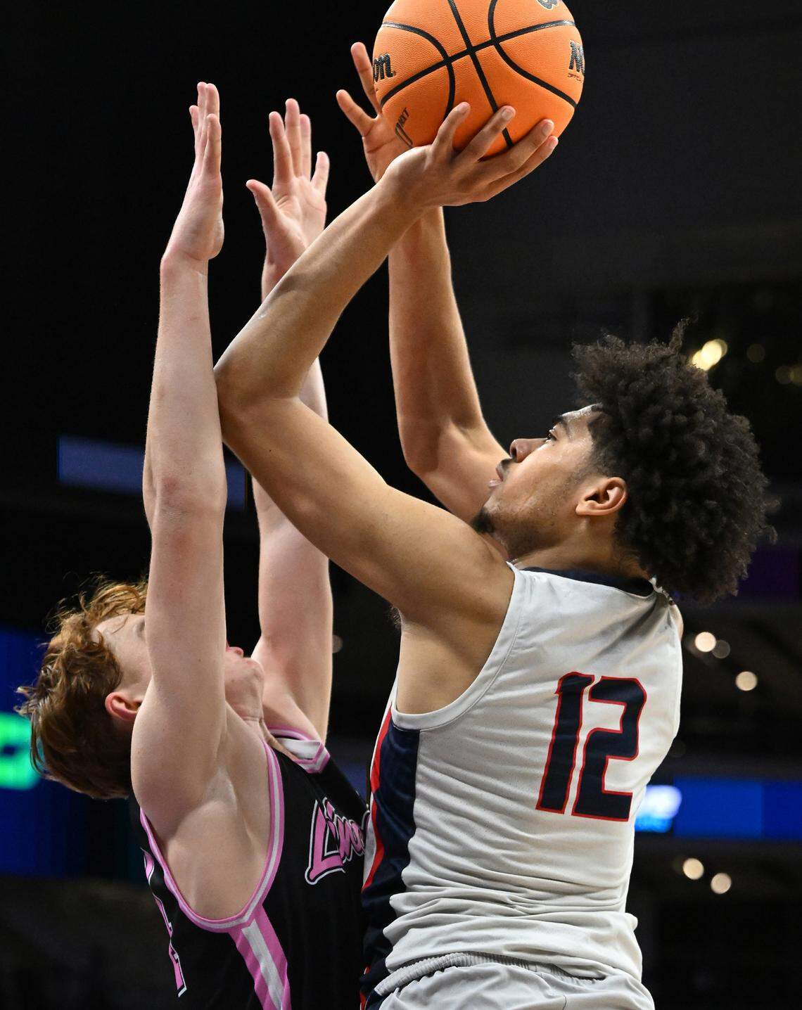 Modesto Christian’s Marcus Washington scores over Lincoln’s Jagger Merolia in the Sac-Joaquin Section Division I championship game at the Golden 1 Center in Sacramento, Calif., Wednesday, Feb. 21, 2024. Washington scored a game high 21 points.