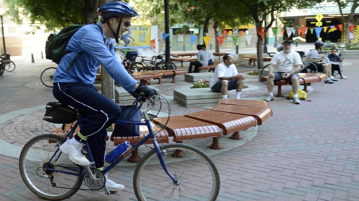 
Dan Johnson of Modesto rides his bike to the 2014 Modesto Bike to Work Day event on the Tenth Street Plaza. This year’s event is Thursday.
