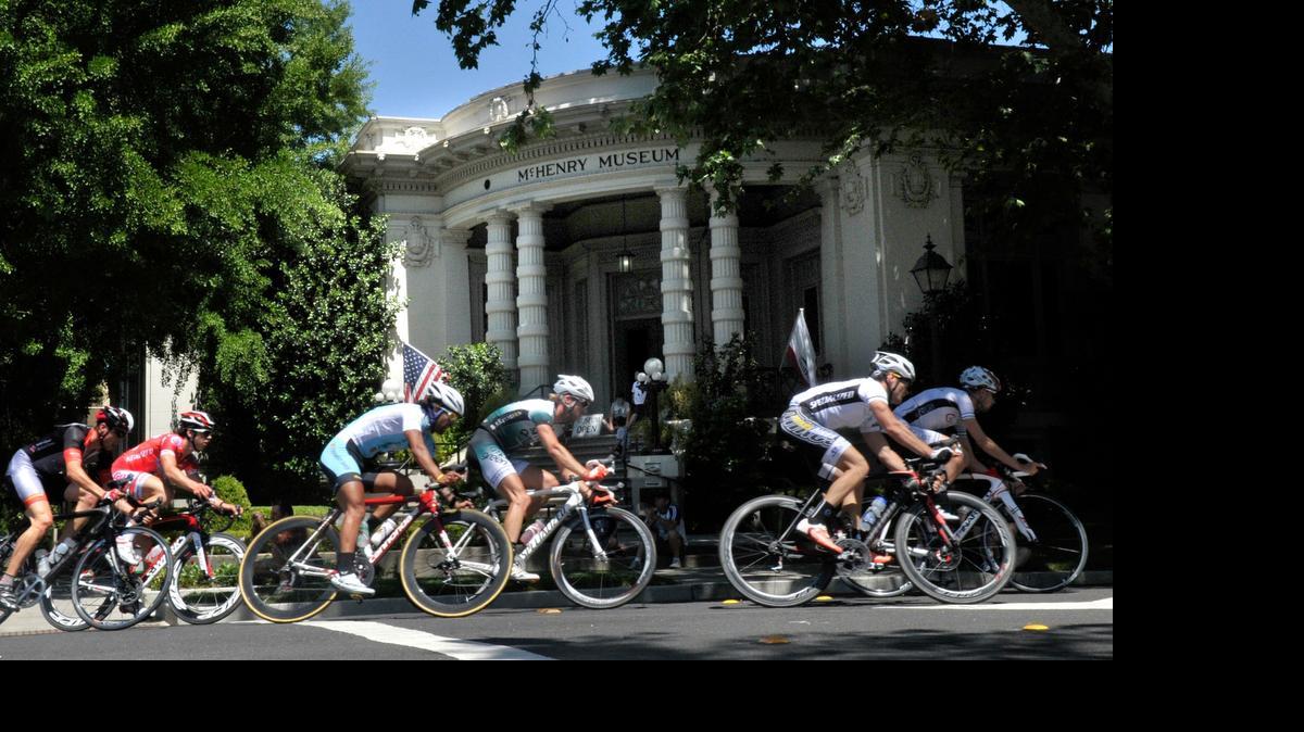 
 Cyclists race past the McHenry Museum in the final race of the day in the 2012 Criterium in downtown Modesto.
