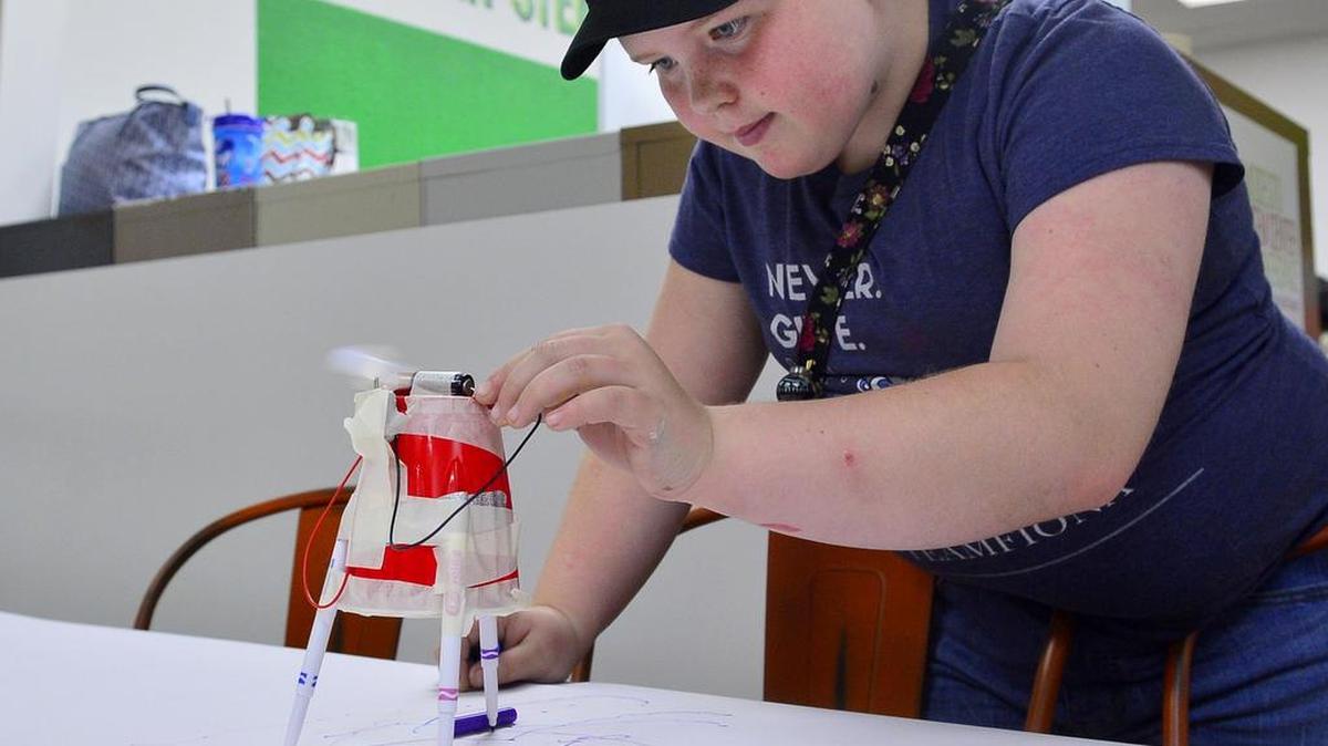 Leia Barlich of troop 917 tests out her Squiggle Bots she built during the grand opening of the Girl Scouts Heart of Central California STEM Center & MakerSpace in Modesto on August 4, 2018. 