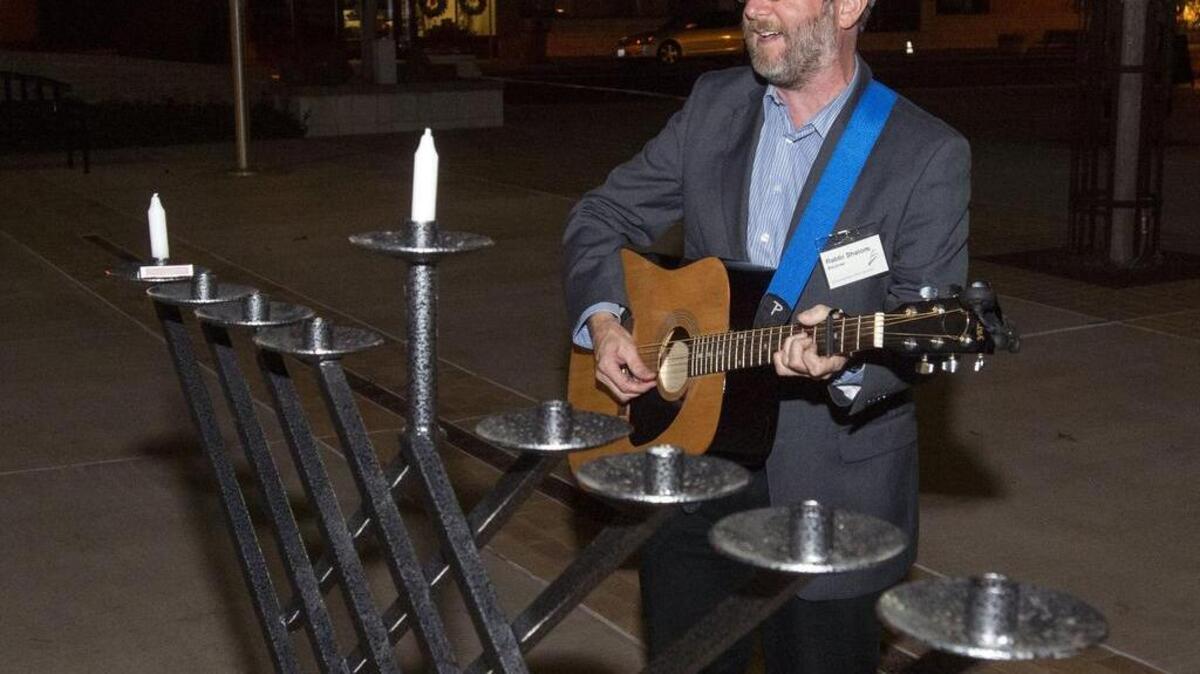 Rabbi Shalom Bachner sings during the Menorah Lighting sponsored by Modesto’s Congregation Beth Shalom in Oakdale on Dec. 6, 2015.