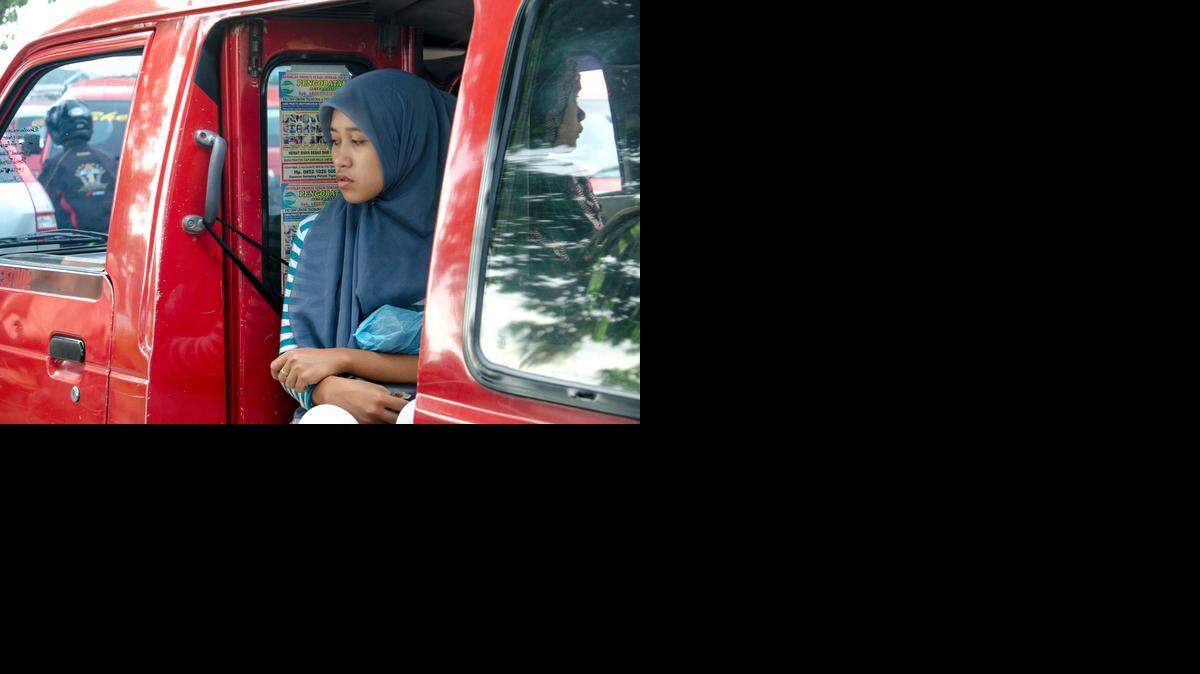 
A young woman rides the bus into the PT Nikomas factory in Tangerang, Banten.
