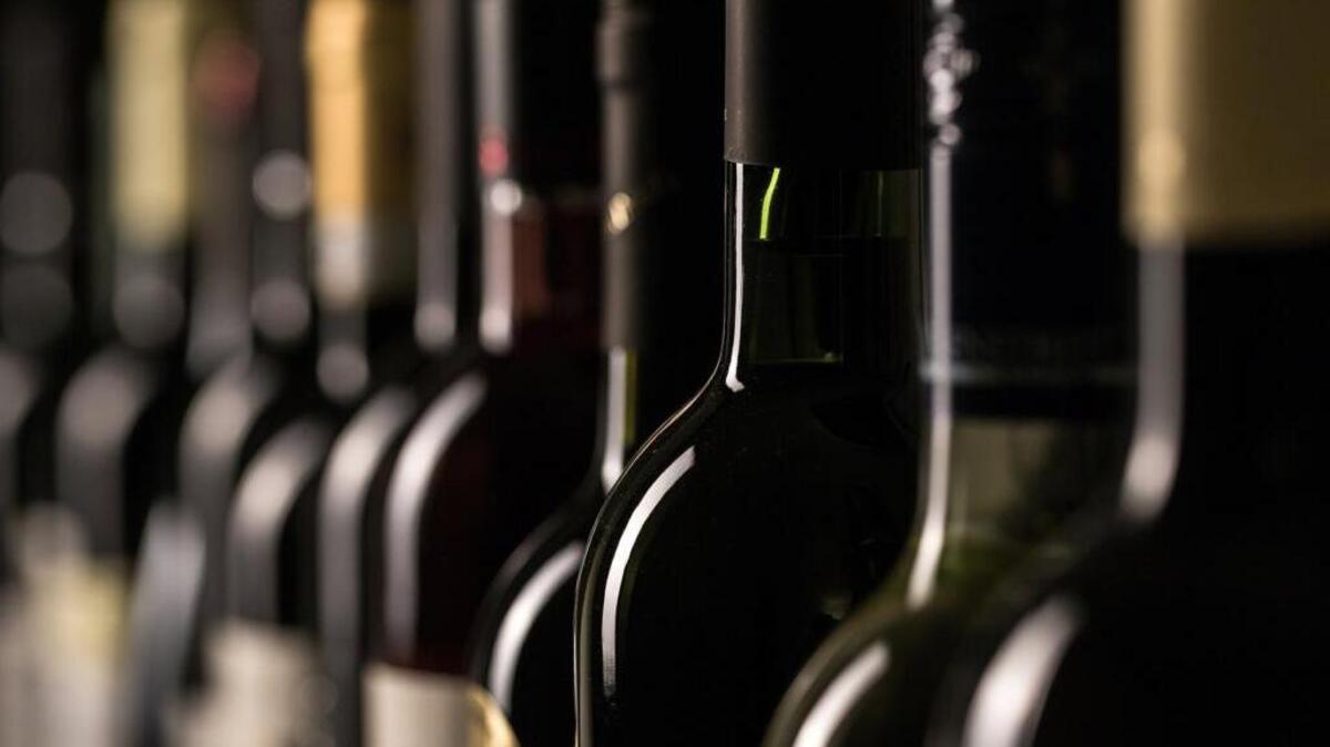 Row of vintage wine bottles in a wine cellar (shallow DOF; color toned image)
