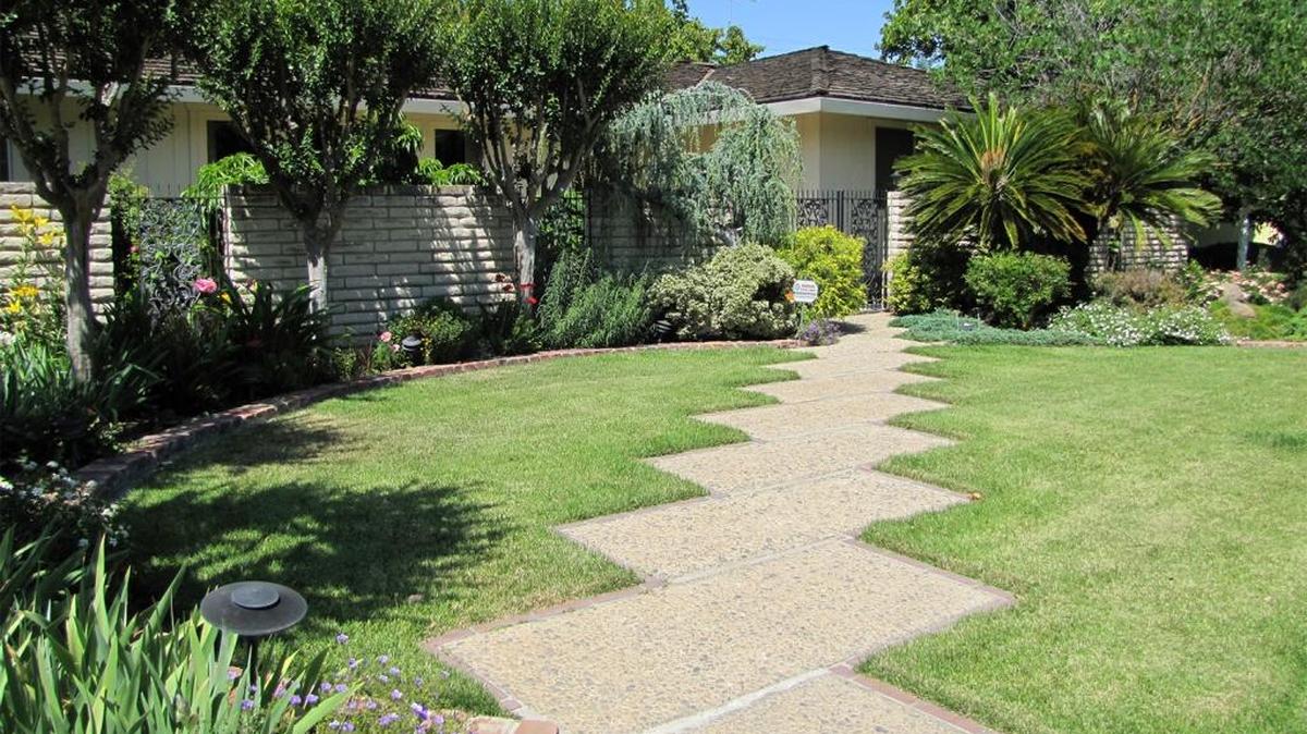 A staggered walkway leads up to the home of Russell and Charlotte Peck. The Modesto Garden Club named their yard Garden of the Month.