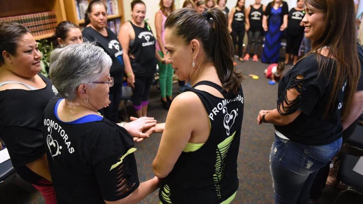 
Rossy Gomar, center, shares a moment with Berta Maes during a promotoras meeting Wednesday, Sept. 9, 2015, at the Family Resource Center in Oakdale.
