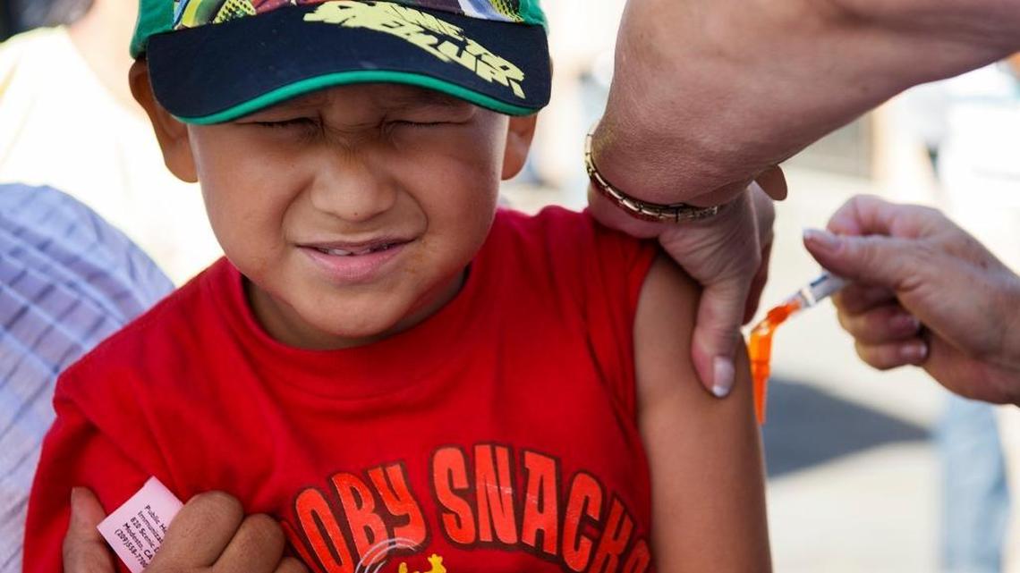 Adrian Alexander Gaonzalez, 5, braces himself as he gets a flu shot during a flu vaccination clinic sponsored by the Stanislaus County Health Services Agency at the El Rematito Crows Landing Flea Market in 2014 in Modesto.