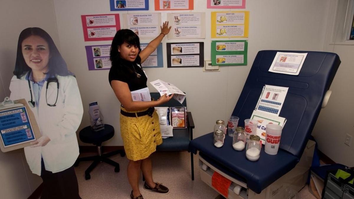 Barbara Obena, a research assistant with Golden Valley Health Center in Merced, talks to visitors in 2011 about diabetes prevention at the grand opening of Riverbank Golden Valley Health Center at Riverbank High School in Riverbank.
