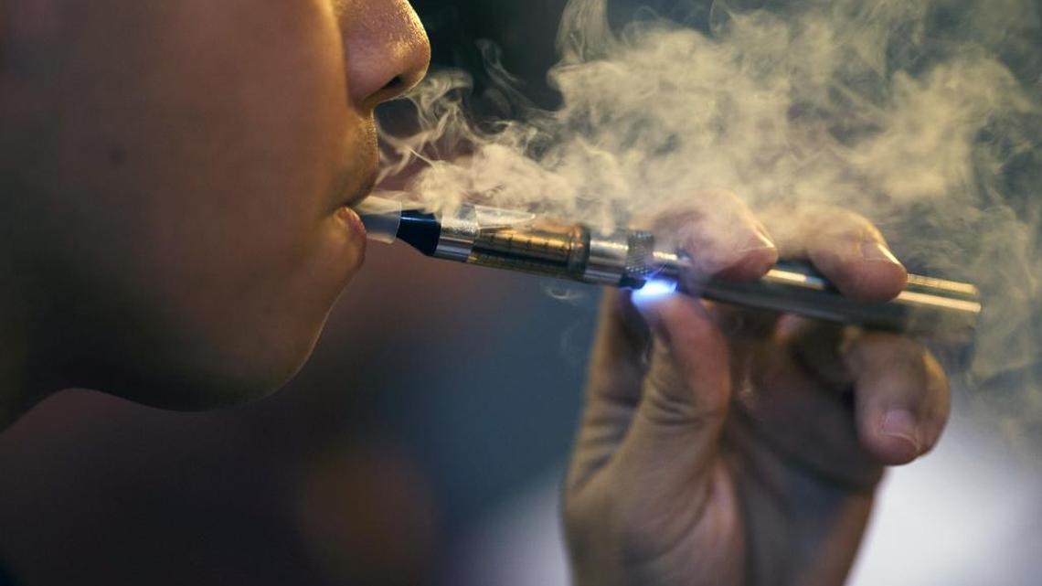 Ken Miguel of San Jose exhales e-cigarette vapor on Oct. 18, 2013 at The Vape Bar in San Jose.