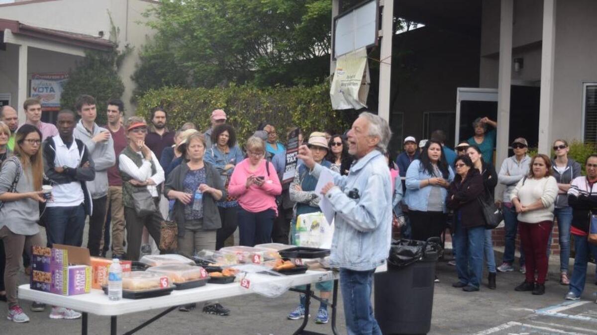 Jack Gribbon, California policy director for Unite Here, a union representing workers in the United States and Canada, gives directions to people preparing to place door hangers on homes in Modesto and Turlock Saturday morning in Modesto, Calif.