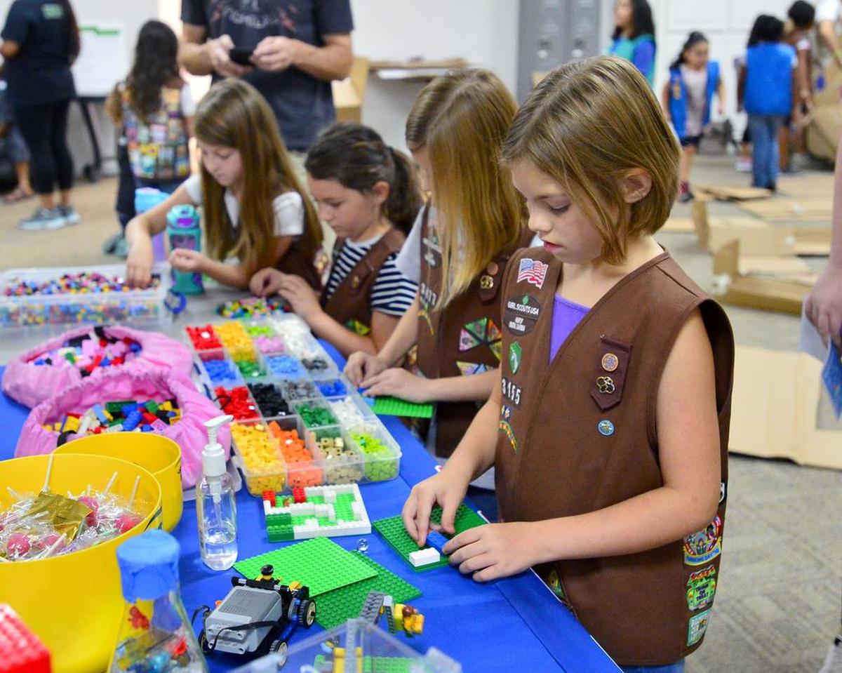 Zoey Scarborough of troop 3155 works on creating a marble maze out of legos during the grand opening of the Girl Scouts Heart of Central California STEM Center & MakerSpace in Modesto on August 4, 2018. 