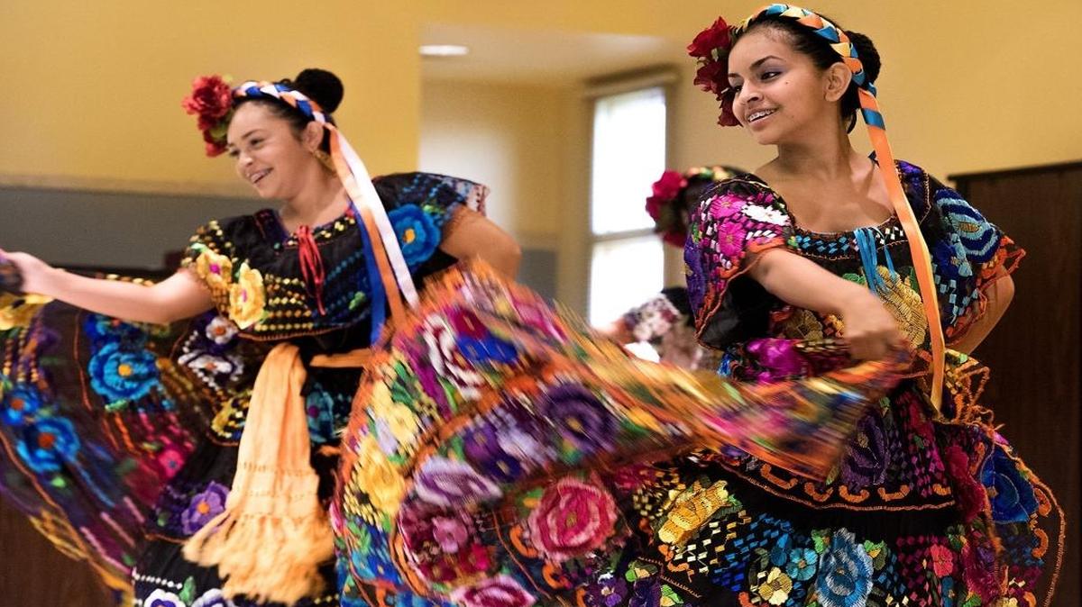 
Anna Rivera, 13, right, and Jackie Aguilar, 14, perform with Ballet Folklorico Los Falcones on Wednesday at Bret Harte Elementary School. 

