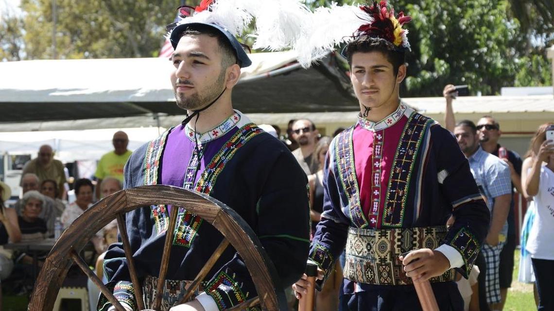 Modesto resident John Morad holds a wheel during a parade celebrating Assyrian inventions at last year’s festival.