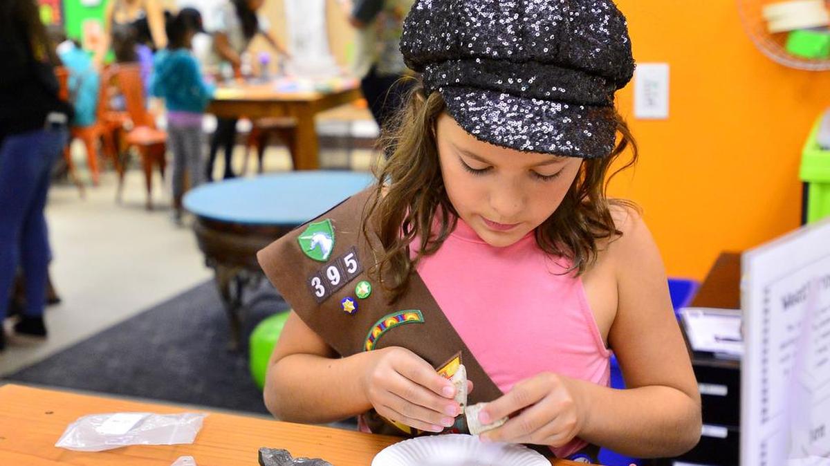 Ariann Vallean examines different rock types as part of the National Ag Science Center area during the grand opening of the Girl Scouts Heart of Central California STEM Center & MakerSpace in Modesto on August 4, 2018. It opened the same week that a grant was awarded to California State University, Stanislaus, to increase the number of math and science teachers it trains.
