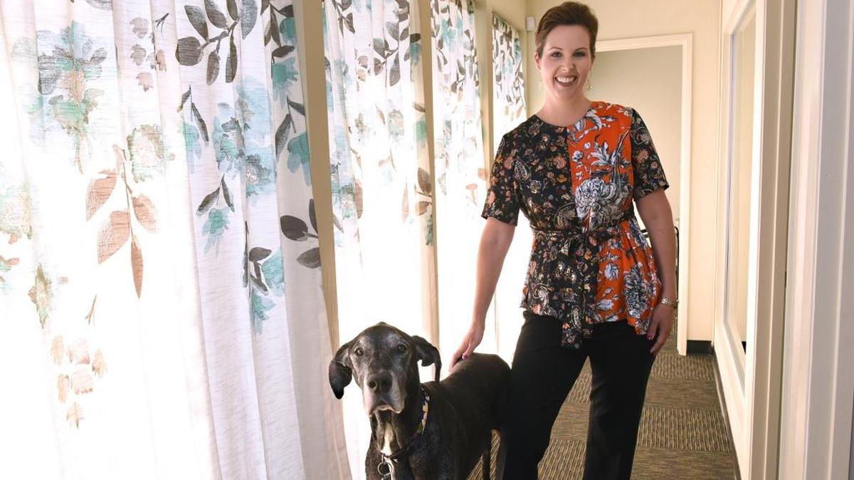 Amy Wolfe, the CEO of AgSafe is pictured at her Modesto office with her dog Polly on Monday morning August 6, 2018. She is a Modesto Bee 20 Under 40 2018 honoree.