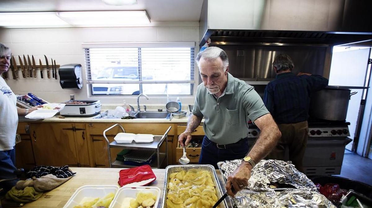 First Congregational Church member Wayne Beck helps prepare meals during the church’s annual corned beef dinner, held at fire Station 12 in Salida, Calif., on Thursday, March, 17, 2016. The Salida Fire Protection District invited the church to hold the dinner there because a driver crashed through the wall of the church kitchen on March 7.