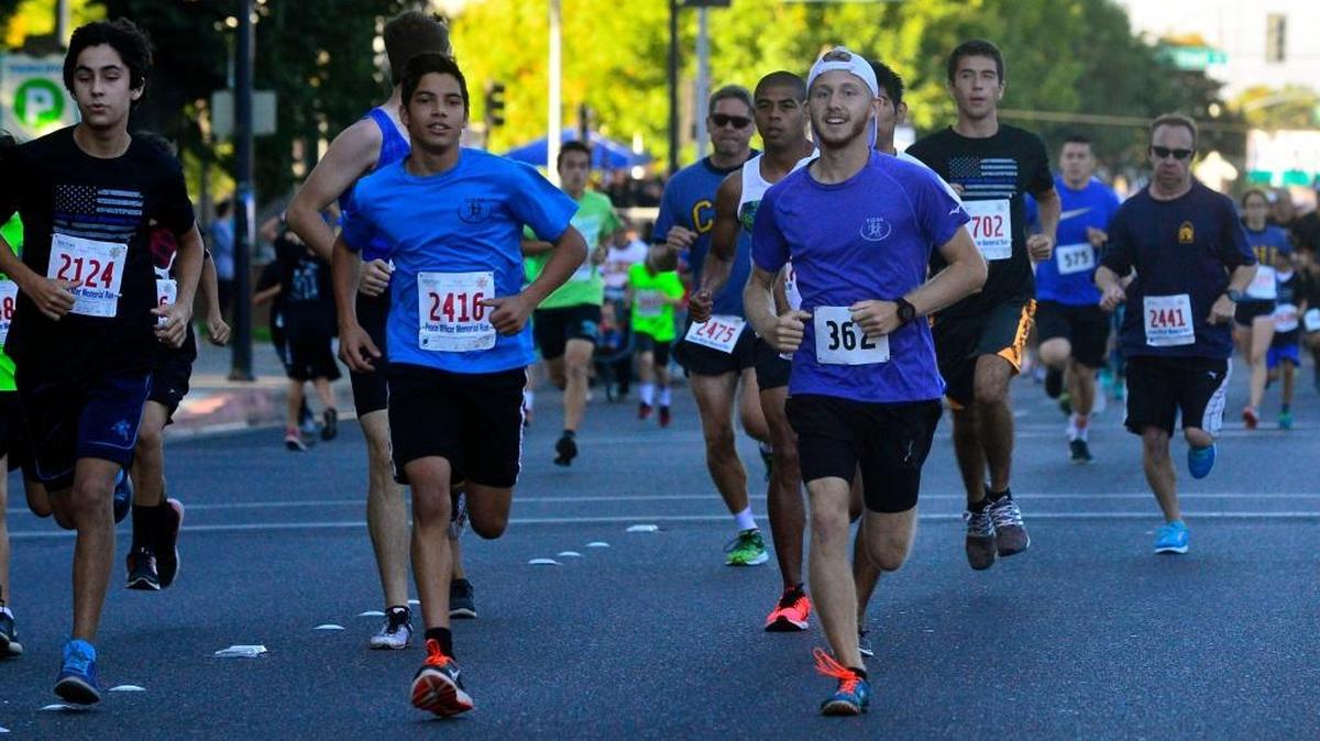 Runners race in the 5K race on I street during the Peace Officers Memorial Run in Modesto, Calif., on Sunday, Sept. 25, 2016.