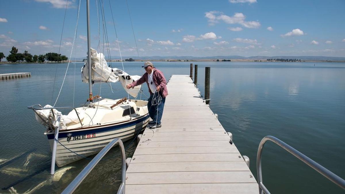 Hughson resident Herman Ward puts his sailboat into the water at Woodward Reservoir in Oakdale, Calif., on Monday, May, 9, 2016.