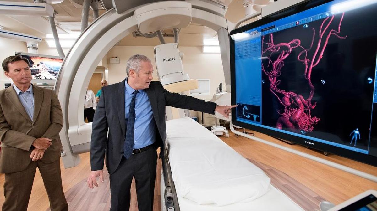 Dr. James Jaffe, middle, demonstrates the new bi-plane fluoroscopy surgical unit at Doctors Medical Center in Modesto, Calif., on Thursday, April 20, 2017. Chief Medical Officer Edward Stanford listens at left.