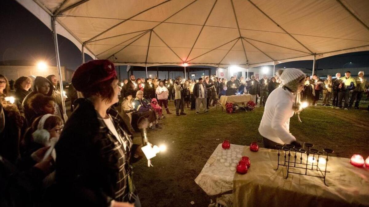 Names of homeless residents who died this year are read aloud during “Not Forgotten,” the annual homeless memorial day vigil at Salvation Army's Berberian Center in Modesto on Wednesday.
