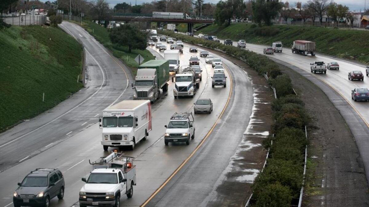 Traffic moves slowly along rain-slicked Highway 99 through Modesto on Friday.