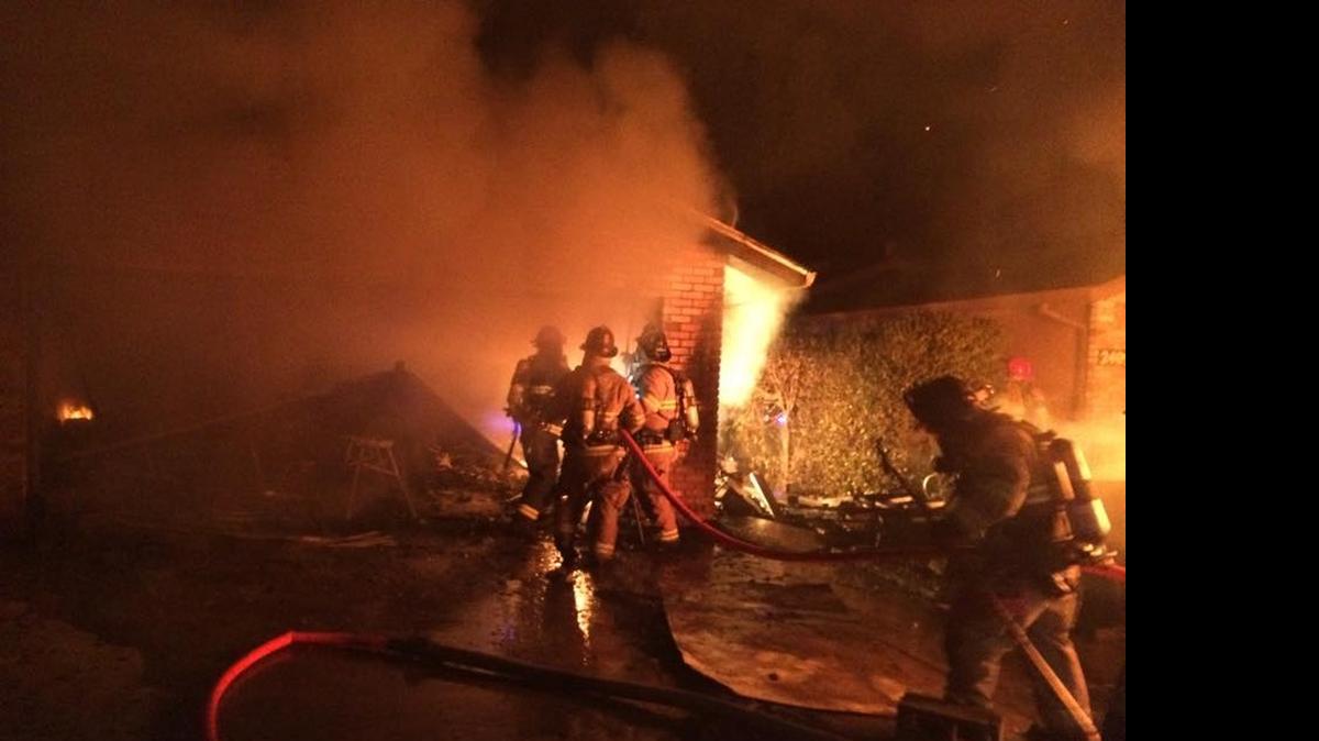 
Firefighters battle a house fire on Counts Court in Modesto on Saturday.
