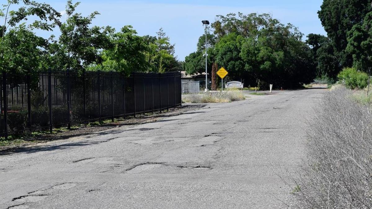 A pothole-filled road near the Peterson Alternative Center for Education in Modesto